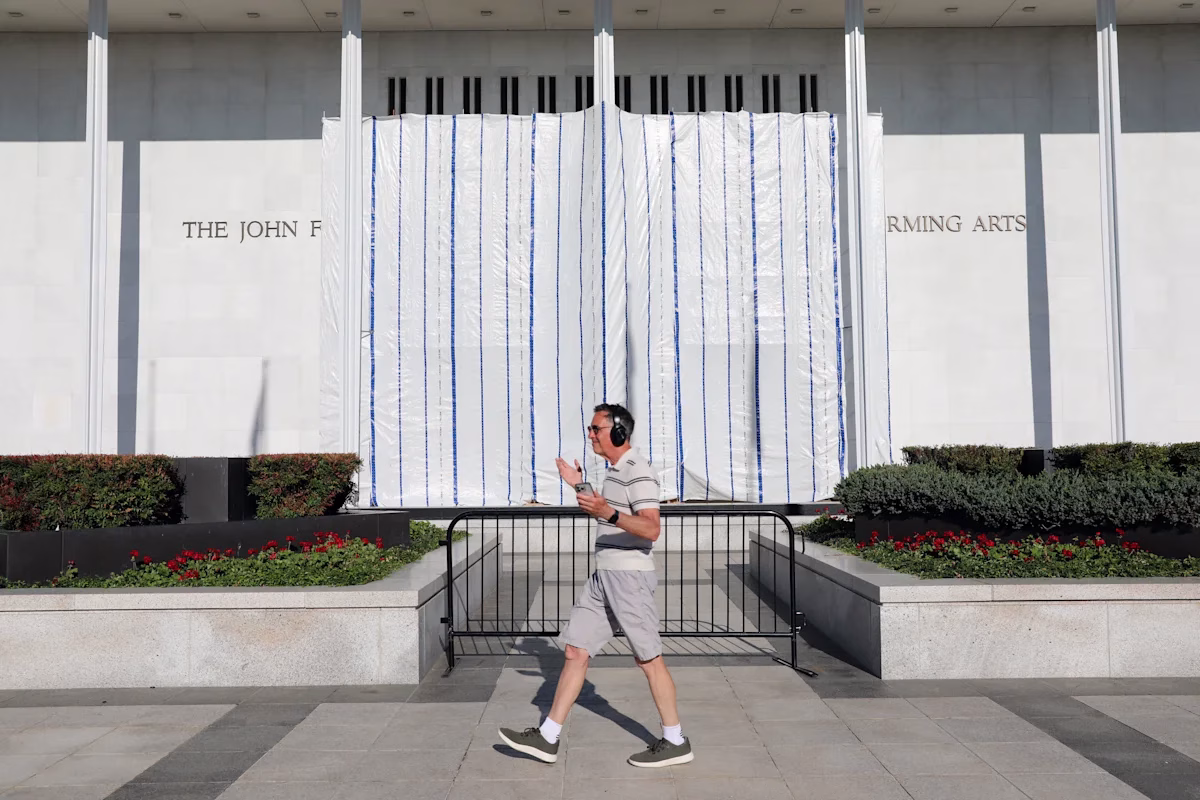 The wall of the John F. Kennedy Center for the Performing Arts is covered in a tarp after President Trump's name was removed.